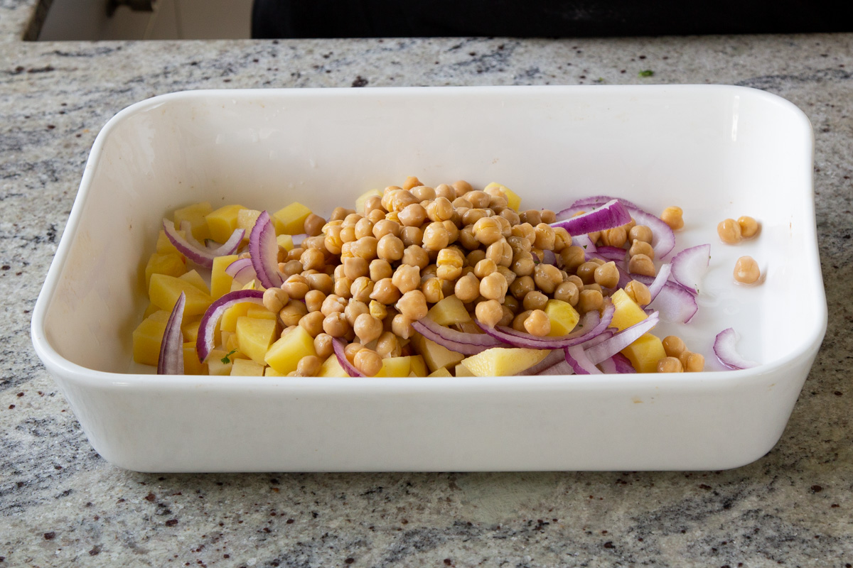 chickpeas, onions, and potatoes in the baking dish