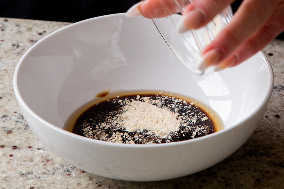 adding garlic powder to the tofu marinade