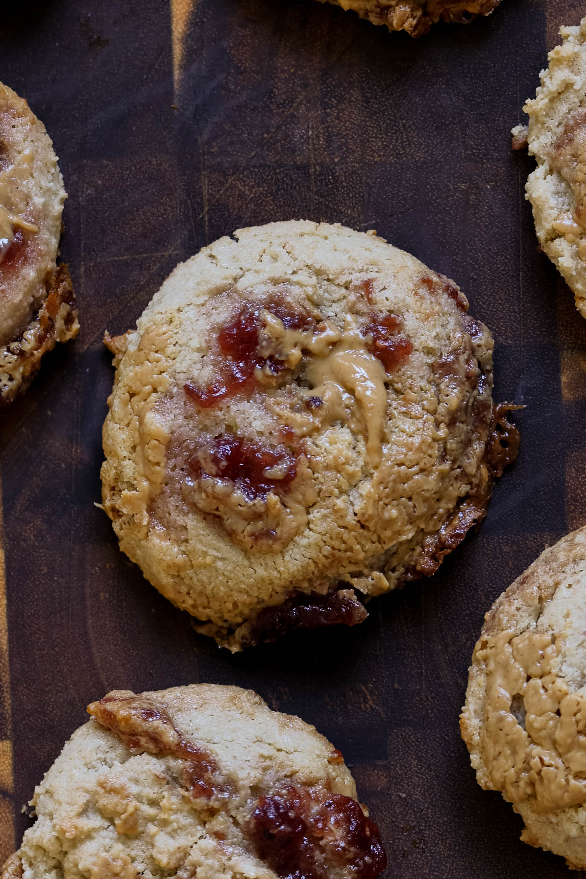 close-up of gluten-free peanut butter and jelly cookies on a wooden cutting board