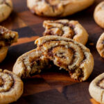 close-up of a pumpkin spice roll cookie broken in half, so you can see the texture