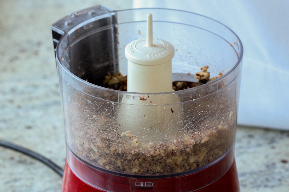 pecans, onion, and garlic in the food processor after running it