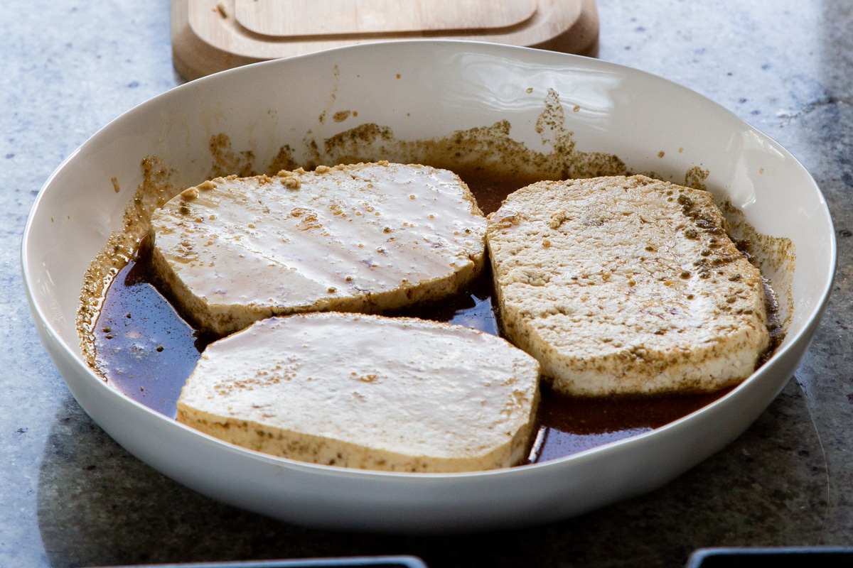 tofu cutlets in the bowl of marinade
