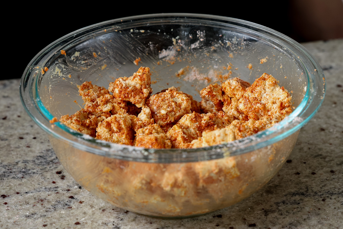 bowl of tofu coated in cornstarch and spices