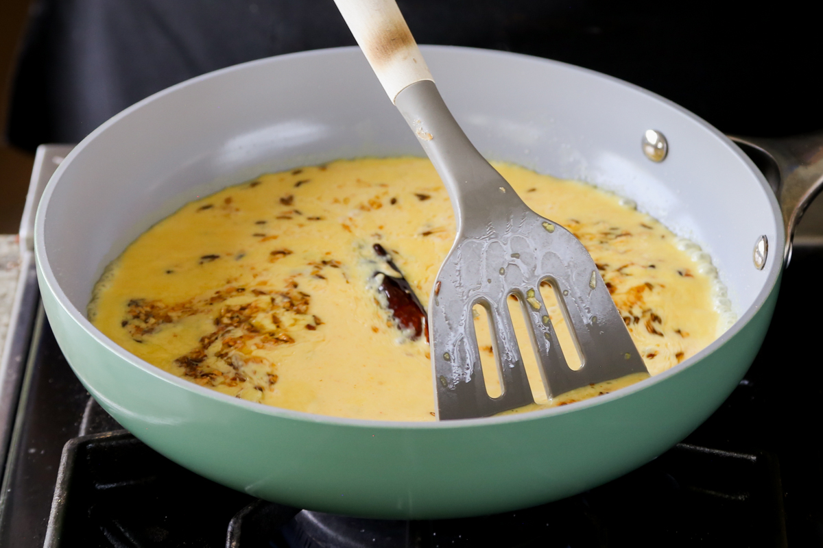 adding the curry sauce to the pan
