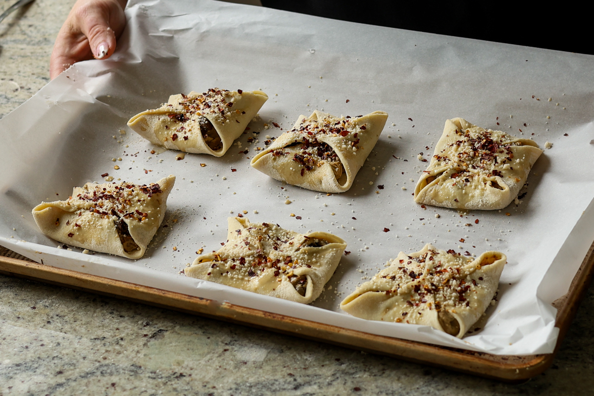 mushrooms puffs on the baking sheet before baking