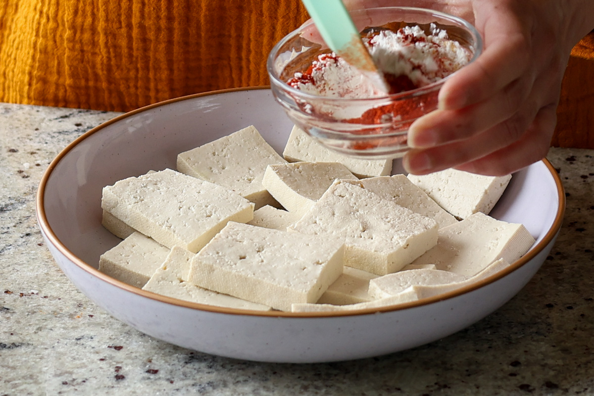 mixing the cornstarch and spices for the tofu