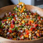 spoon serving up mango chickpea salad