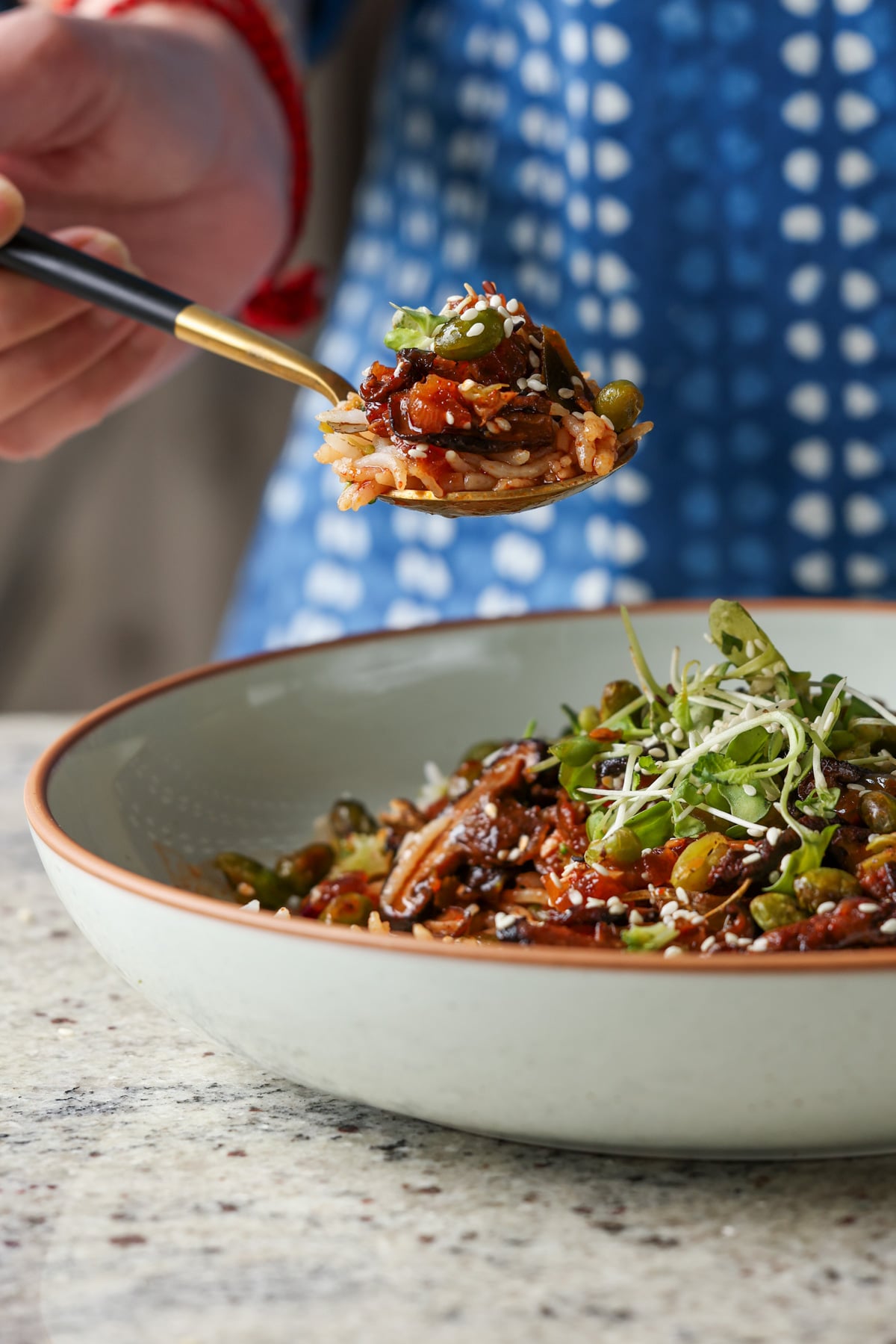 spoon taking a bite of crispy edamame bowl