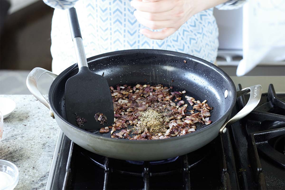 adding more herbs and spices to the pan