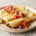 chickpea mushroom taquitos on a plate with pico de gallo