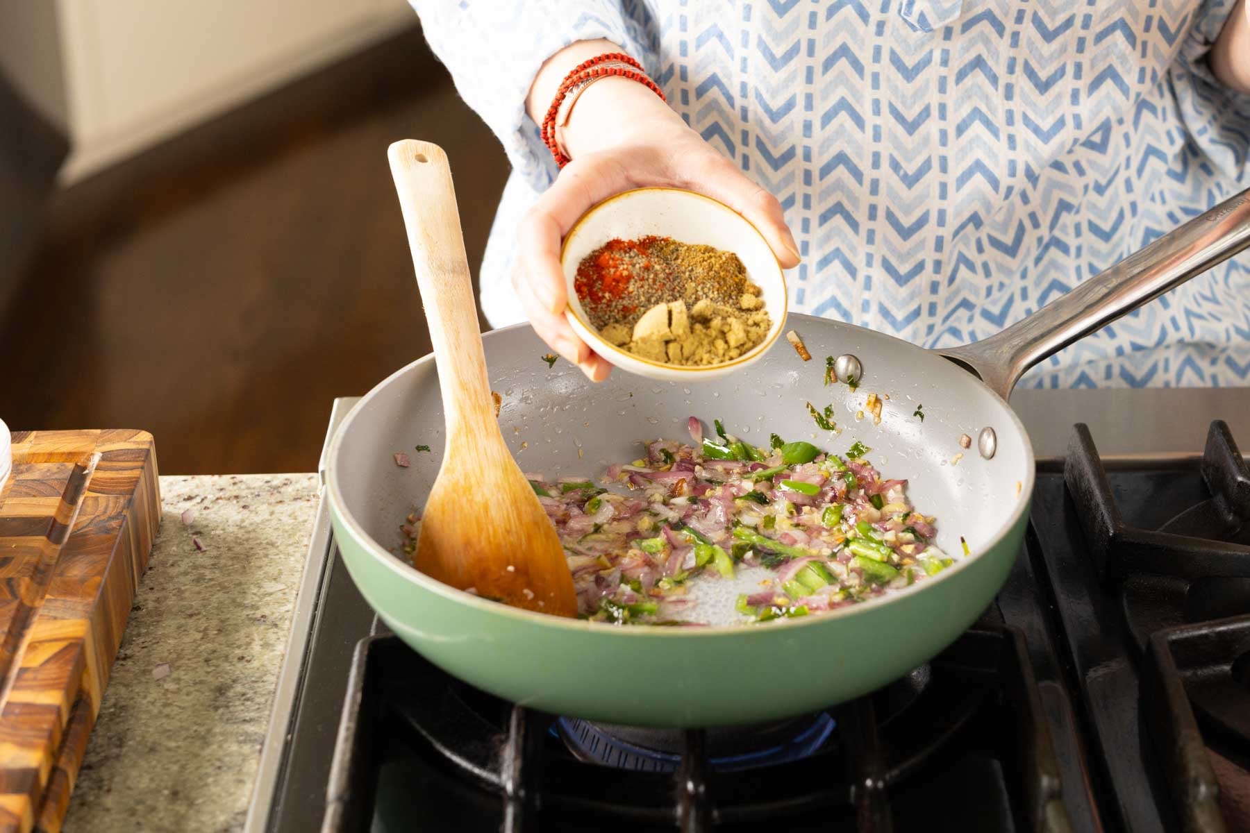 adding spices to the pan