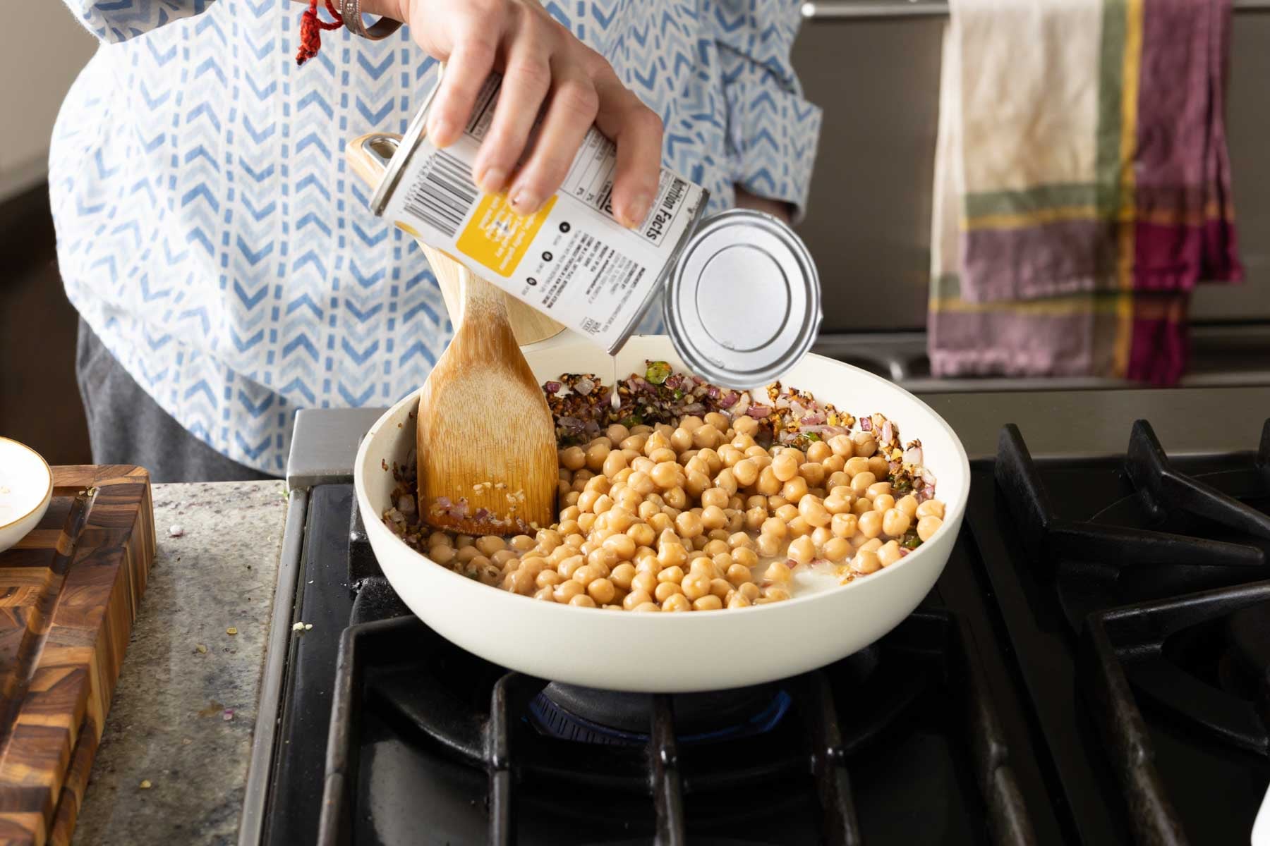 adding drained chickpeas to the pan