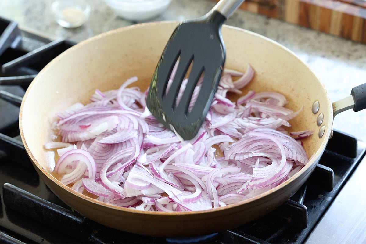 adding onions to the pan