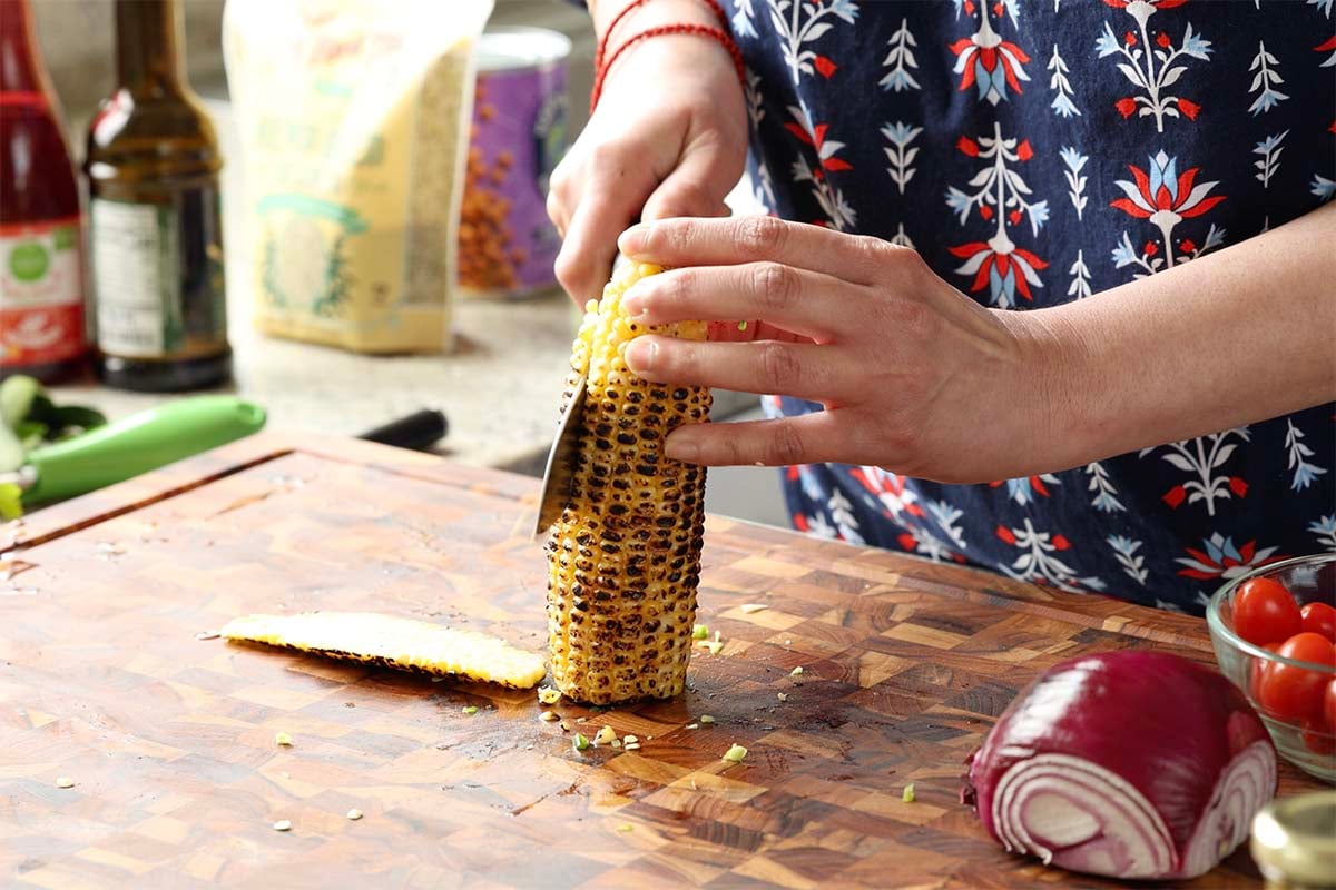 slicing the corn off the cob