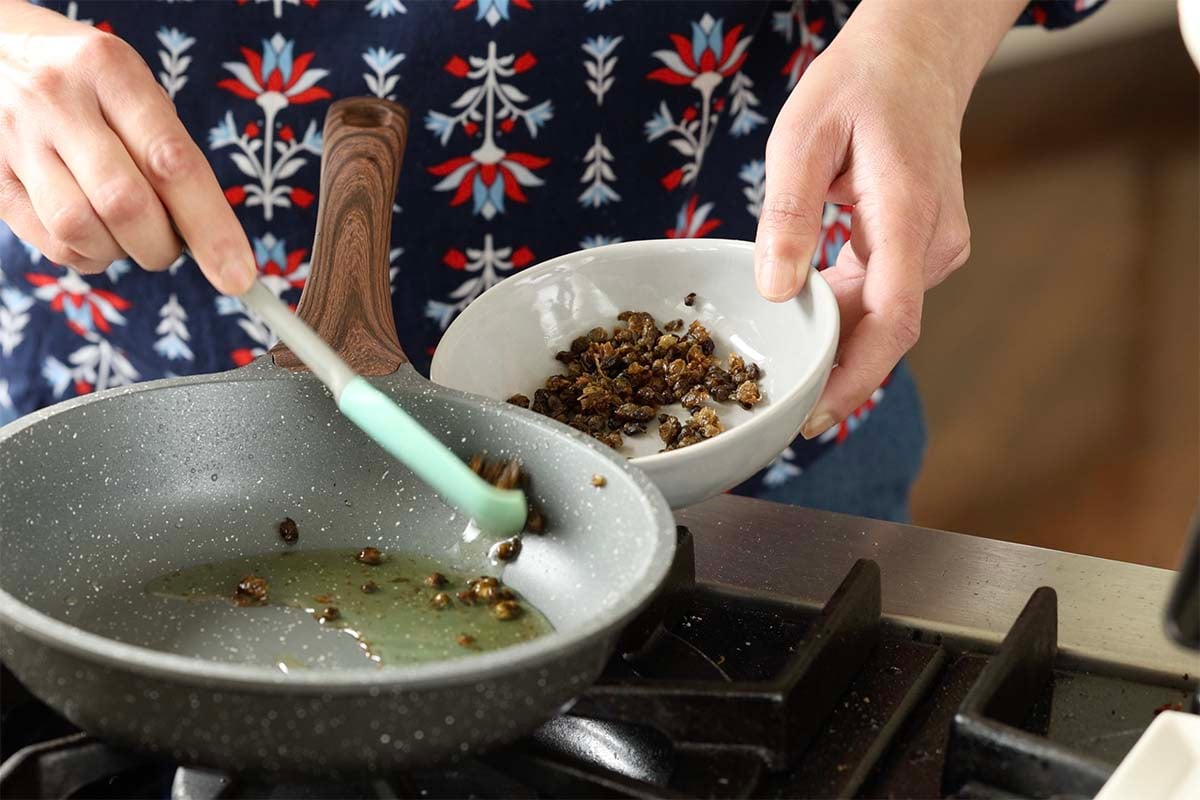 removing the crispy capers from the pan