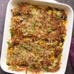 hashbrown casserole in the pan after adding the hashbrowns on top